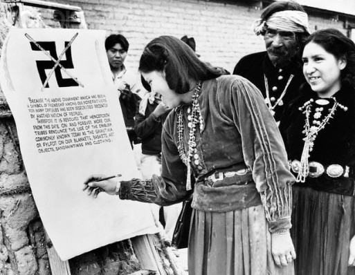 28 Feb 1940, Tucson, Arizona, USA --- 2/28/40-Tucson, Arizona: Florence Smiley and Evelyn Yathe, Navajos of Tucson, Arizona are shown signing the imposing parchment document which formally outlawed the Swastika symbol from designs in Indian art, such as basket and blanket weaving. Four tribes, Navajos, Papagos, Apaches and Hopis banned the symbol which was in use by the Indians long before it came to have a sinister significance. The document tells why Indians banned it. --- Image by © Bettmann/CORBIS