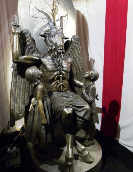 A  bronze statue of Baphomet -- a goat-headed winged deity that has been associated with satanism and the occult -- is displayed by the Satanic Temple during its opening in Salem